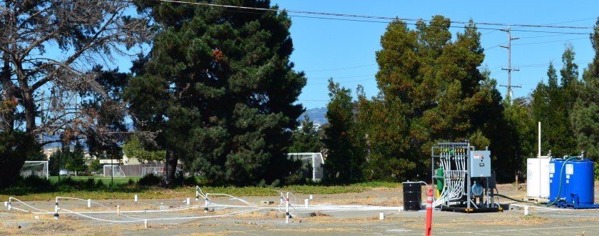 Former location of auto service station and car wash where fuel leaked into the ground.  Part of the site is receiving follow-up cleanup work.  Near Main St. and Pacific.  Soccer field in background.