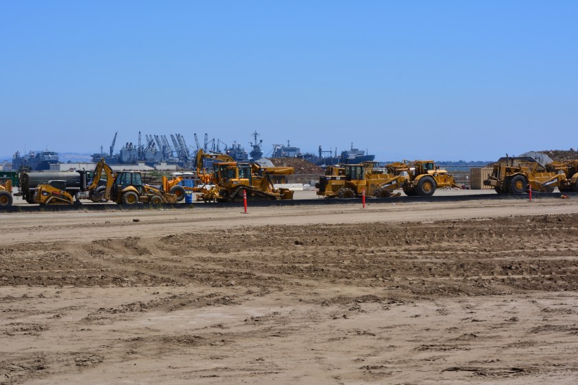 Construction equipment at Site 2.  Looking east with maritime ships in background.