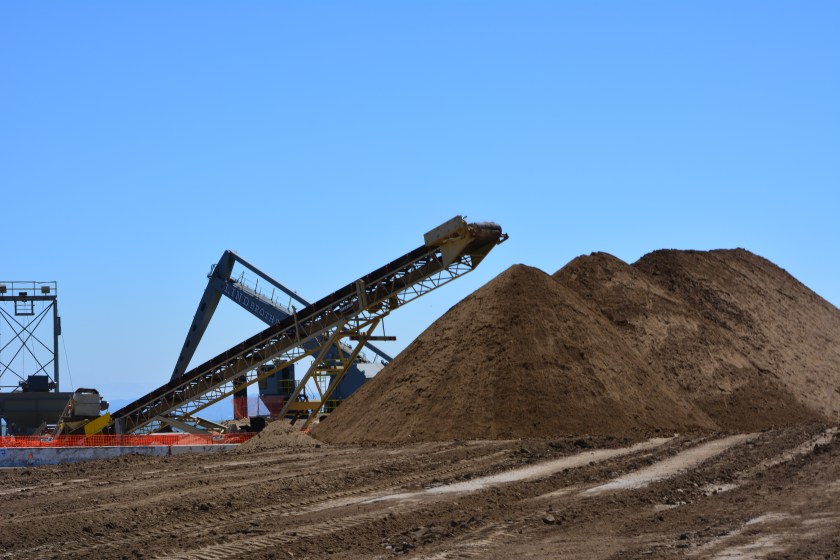 Soil from Decker Island being off loaded from barge at southwest corner of Alameda Point.