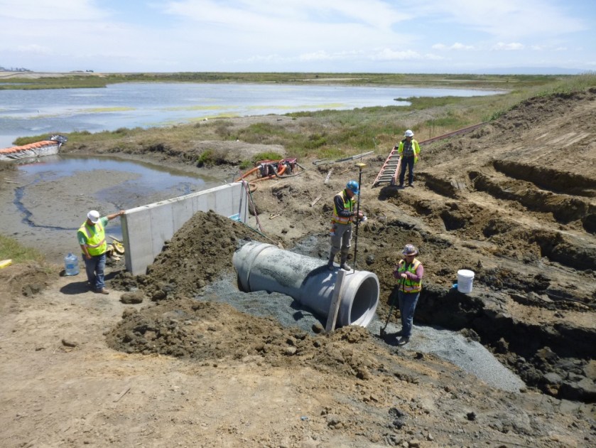 New culvert being installed connecting San Francisco Bay, which is to the right, and North Pond of the West Wetland at Alameda Point.  Navy photo taken 5/22/14.