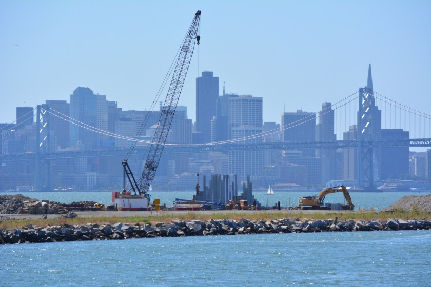 Site 1 cleanup project with crane.  Oakland Estuary in the foreground and San Francisco in the background.