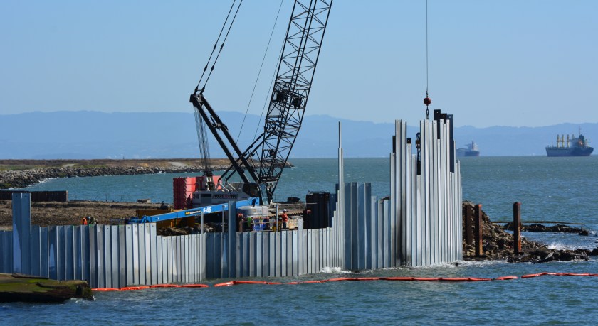 Three of the waste isolation cells under construction at northwestern tip of Alameda Point.  A total of 15  cells, each one separated by a wall behind the face of the barrier, will be constructed here.