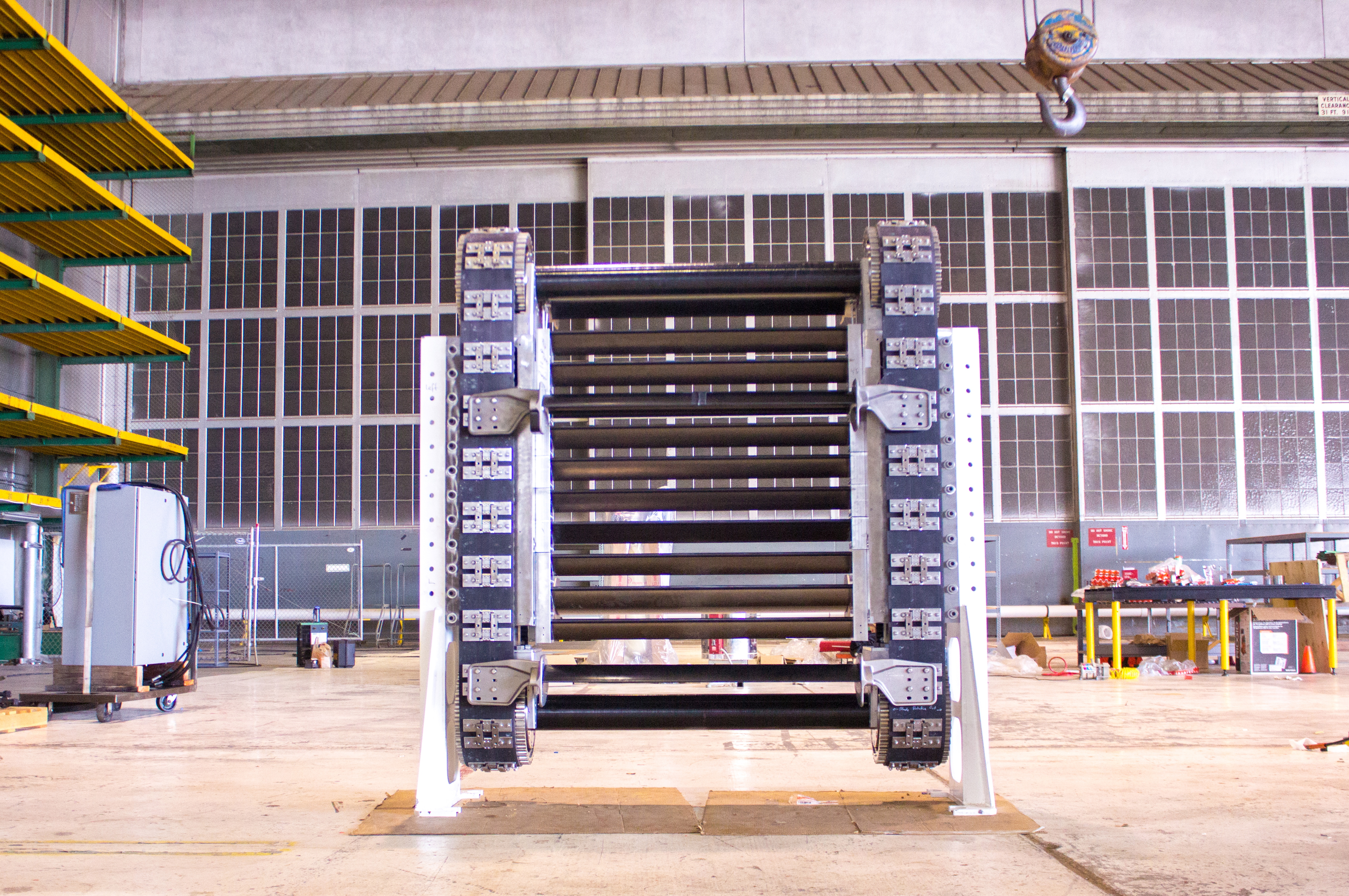 HydroEngine drive system called a cassette. Blades connected to conveyor belts are moved by water guided by fins called guidevanes (not shown). As water contacts first set of blades, the belt is moved upward, while exiting water drives the rear set of blades downward. Natel Energy photo. Used by permission.