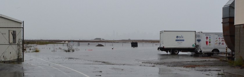 Flooding on south and west sides of Building 25 used by Brix Beverage.  Looking west.