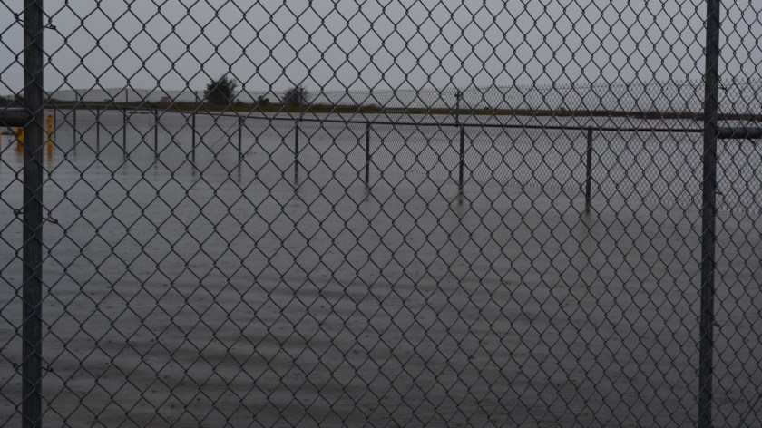 Flooding at rear of Building 25.  Fence in background is VA boundary.  On the other side is the Runway Wetland.