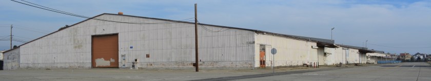 Building 118 was formerly a warehouse and then became the Navy Exchange Building, which was divided to create a mall. Bayport is in the background.