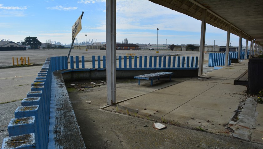 Building 118 - former Navy Exchange Building - with bulb-out sitting areas. Maritime ships at Seaplane Lagoon in background. West Trident Avenue in front of Building 118 will become a landscaped boulevard and a through street from Main Street (currently blocked).