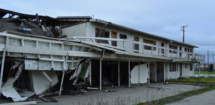 Collapsing Navy housing in the Main Street Neighborhood sub-district, with Bayport in the background.