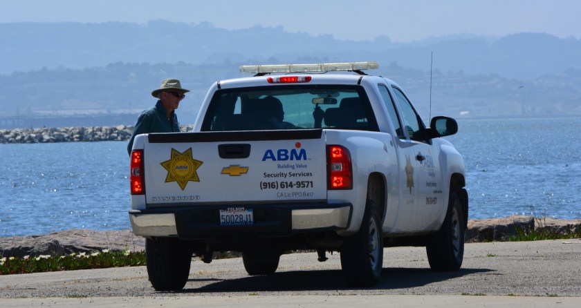 Security guard telling car driver and his friend they had to leave.