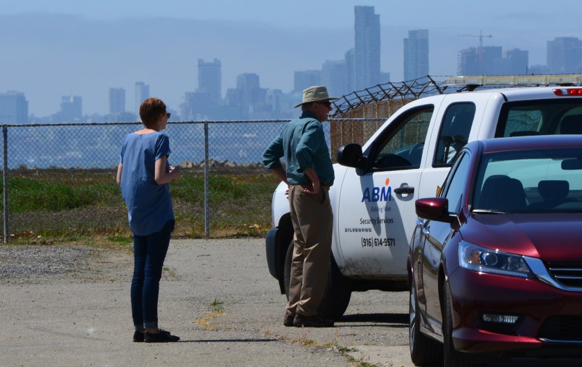Two visitors to west side of Seaplane Lagoon shoreline being ordered to leave by security.