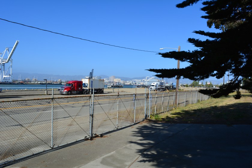 Main Street entrance to O Club parking lot.  Oakland Estuary and arriving ferry on the left.