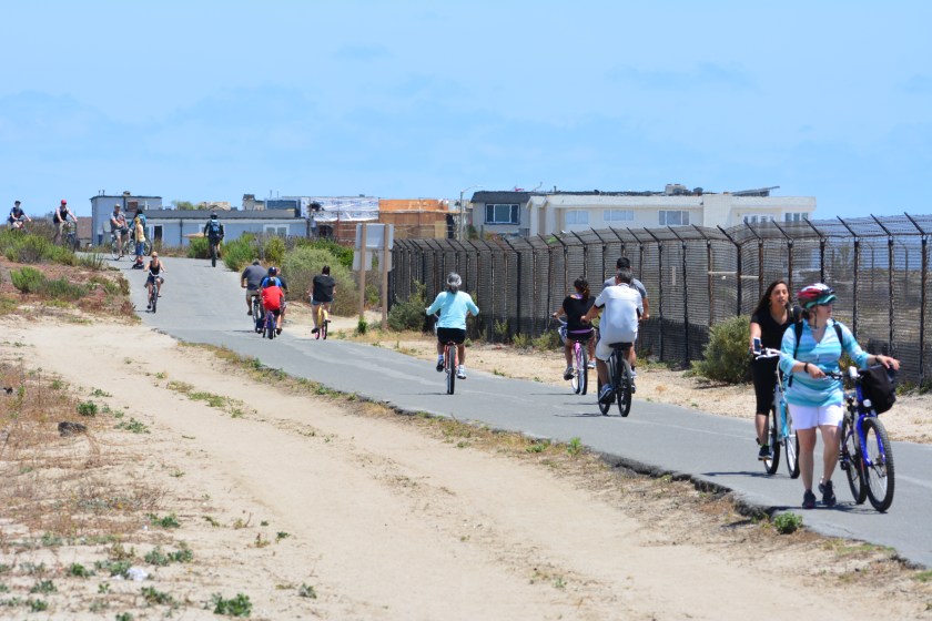 Huntington Beach Bike Trail.  Least tern preserve is on the right.  Pacific Coast Highway is about 20 feet to the left and out of view.  City of Newport Beach is in the background.