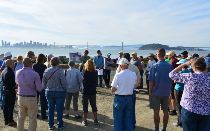 Tour group at the western shoreline listening to Dr. Peter Russell explaining environmental cleanup work the Navy has completed at Site 2.