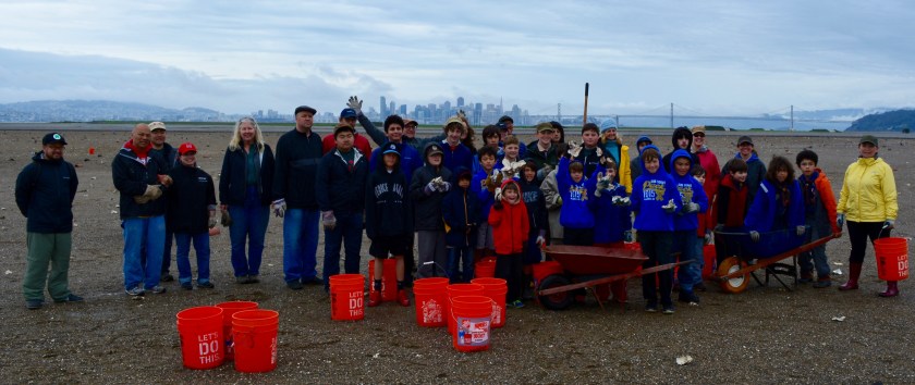Boy Scouts and Cub Scouts, some holding up oyster shells, at the least tern nesting site April 10, 2016.
