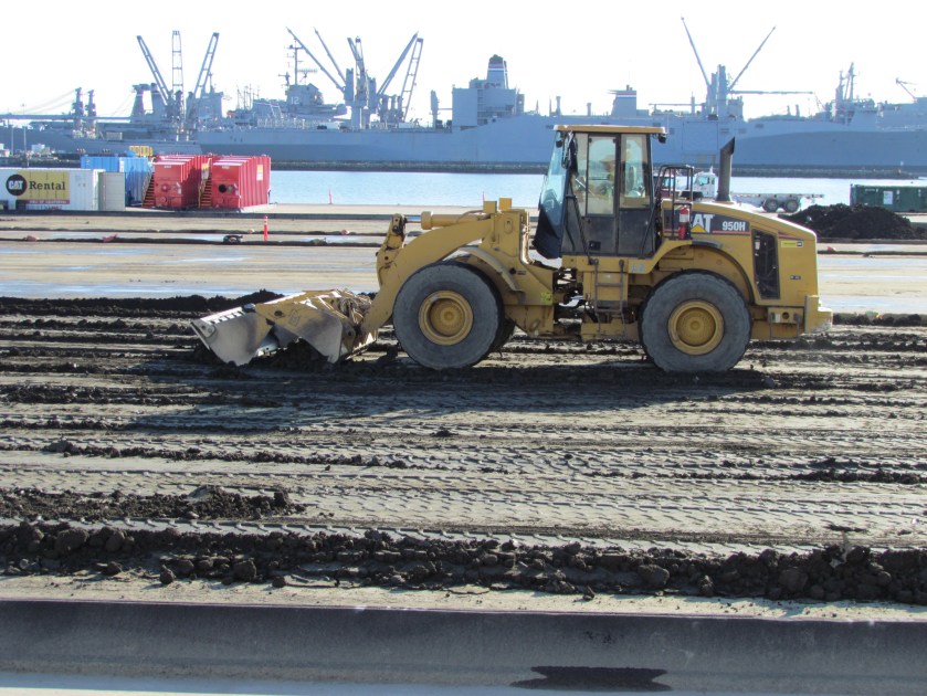 Spreading out dredge sediment for radiation scanning on the north side of the Seaplane Lagoon, December 2011. Seaplane Lagoon in background.