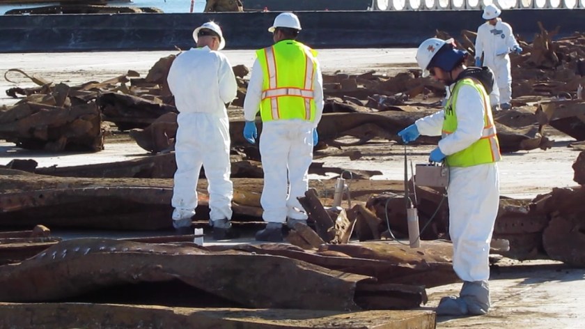 Navy contractor scanning the remnants of an old barge for radiation in January 2012. The barge had to be demolished and removed piece by piece from the northwest corner of the Seaplane Lagoon prior to dredging. No radiation was found. The Navy recycled the metal.