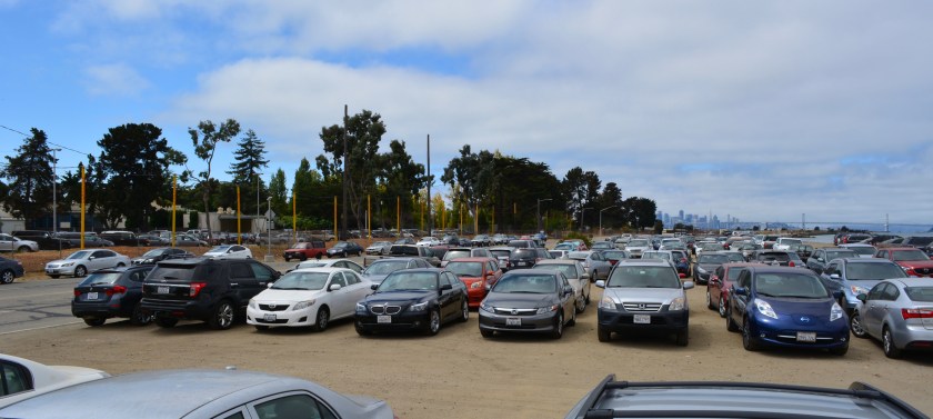 Unpaved city-owned parking lot on Main Street west of dog park used by ferry riders.